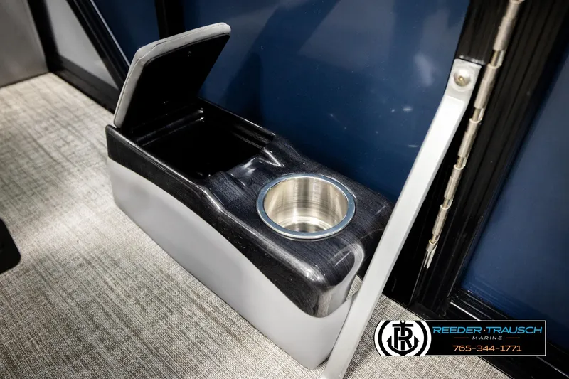 Slide: The Image of 2026 Avalon LSZ QLS boat cup holder and storage compartment, Reeder-Trausch Marine branding. - 42