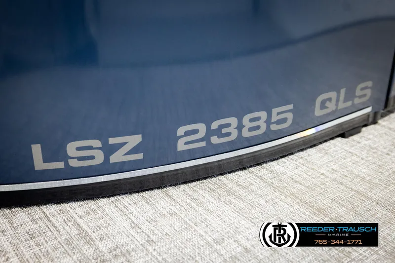Slide: The Image of 2026 Avalon LSZ QLS boat model with "LSZ 2385 QLS" branding, Reeder-Trausch Marine logo. - 52