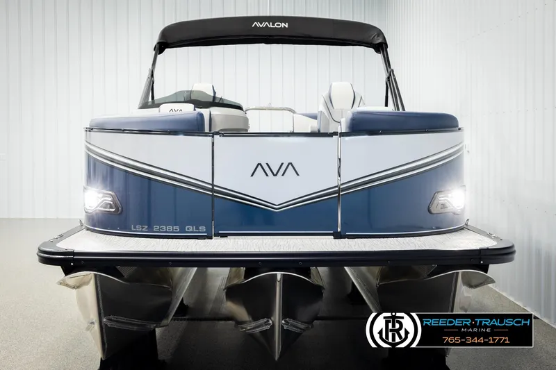 Slide: The Image of 2026 Avalon LSZ QLS pontoon boat, front view, in showroom setting. - 8