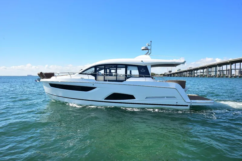 Slide: The Image of 2022 Sealine C430 yacht cruising on open water under clear blue skies. - 16