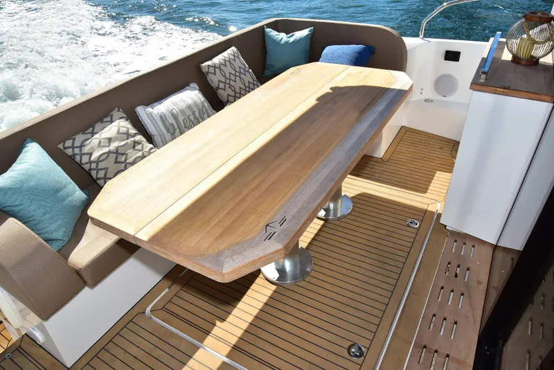 Slide: The Image of Luxury Sealine C430 yacht deck with elegant wooden table and cushioned seating, 2022 model. - 22