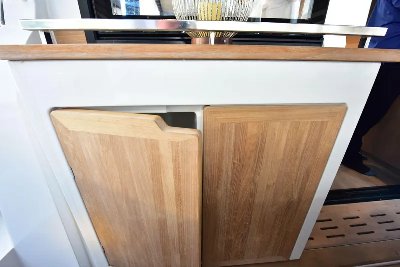 Slide: The Image of 2022 Sealine C430 yacht interior with wooden cabinetry and modern design elements. - 34