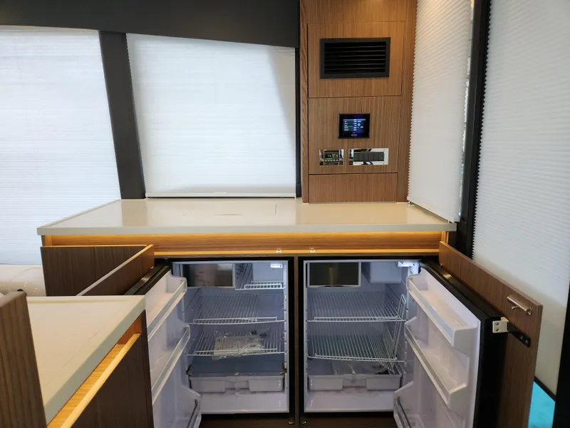 Slide: The Image of Modern kitchen interior of 2022 Sealine C430 yacht with open double-door refrigerator. - 36