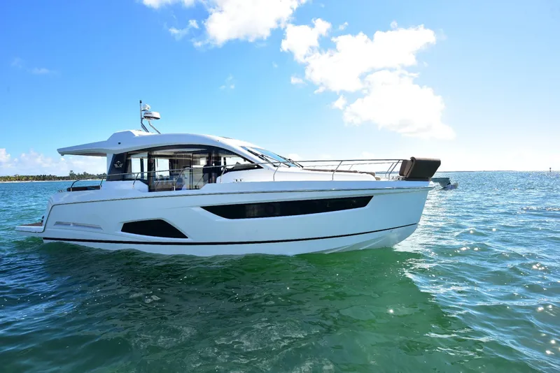 Slide: The Image of 2022 Sealine C430 yacht on open water under clear blue sky. - 5