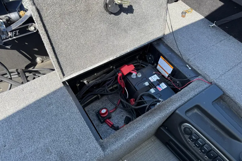 Slide: The Image of 2019 Alumacraft Competitor 185 CS boat battery compartment with wiring and controls. - 12