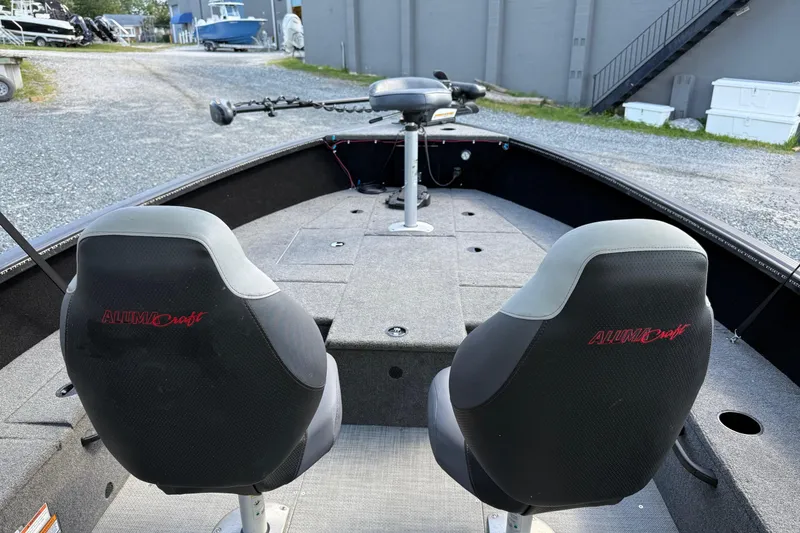 Slide: The Image of 2019 Alumacraft Competitor 185 CS boat interior with two seats and trolling motor. - 14