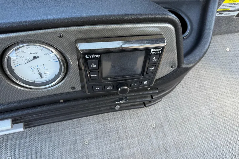 Slide: The Image of 2019 Alumacraft Competitor 185 CS dashboard with gauge and Infinity Bluetooth stereo. - 16