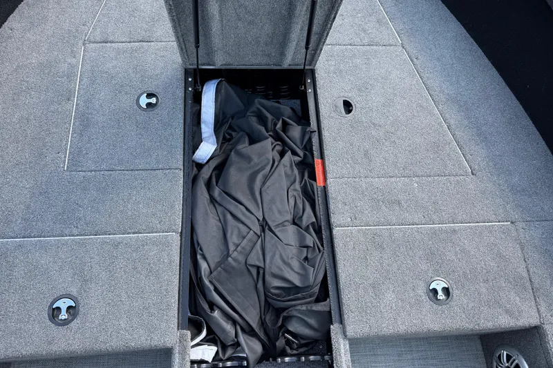 Slide: The Image of 2019 Alumacraft Competitor 185 CS boat storage compartment with cover inside. - 8