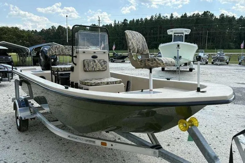 Slide: The Image of 2026 Carolina Skiff E18 JVX TH boat on trailer, parked outdoors. - 3