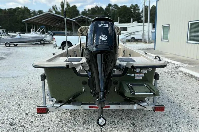 Slide: The Image of 2026 Carolina Skiff E18 JVX TH boat with 75 HP engine, parked outdoors. - 4