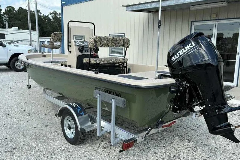 Slide: The Image of 2026 Carolina Skiff E18 JVX TH boat with Suzuki outboard motor on trailer. - 5