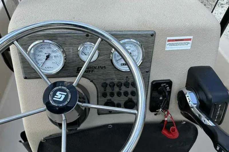 Slide: The Image of Steering console of 2026 Carolina Skiff E18 JVX TH boat with gauges and controls. - 7
