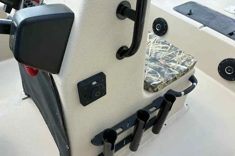 Slide: The Image of 2026 Carolina Skiff E18 JVX TH boat interior with JBL audio and rod holders. - 9