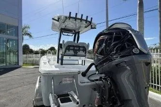 Slide: The Image of 2026 Sportsman Masters 227 Bay Boat displayed outside dealership with palm trees. - 3