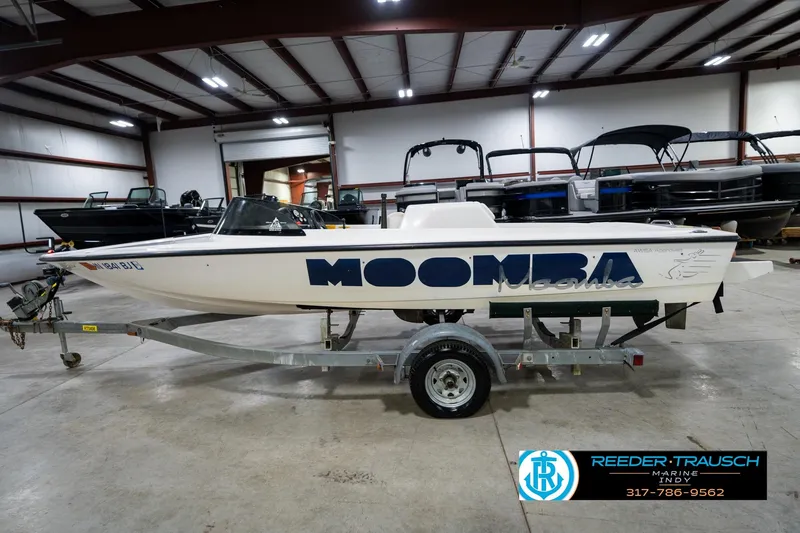 Slide: The Image of 1997 Moomba Boomerang boat on trailer in indoor showroom. - 10