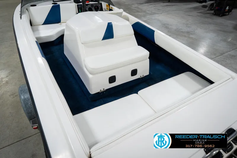 Slide: The Image of 1997 Moomba Boomerang boat interior with white and blue seating and steering wheel. - 14