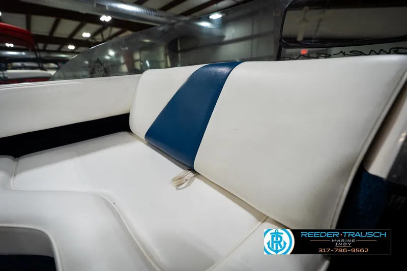 Slide: The Image of 1997 Moomba Boomerang boat interior with white seating in a showroom. - 19