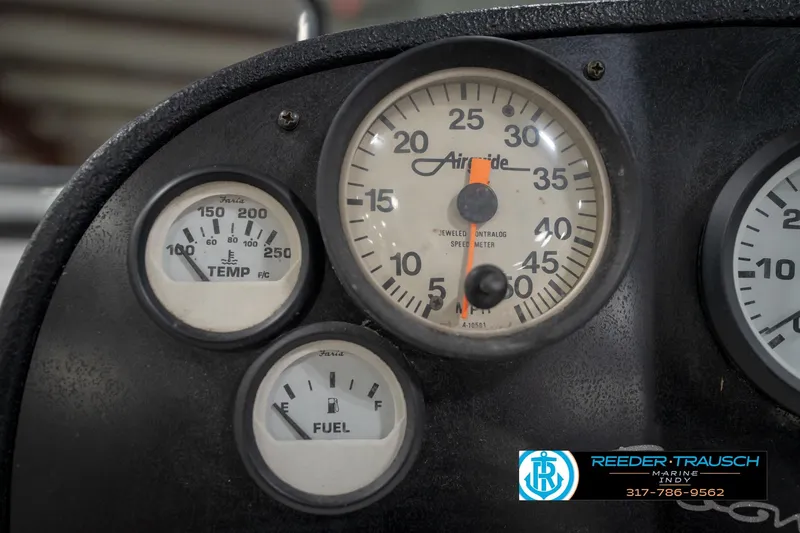 Slide: The Image of Control panel of a 1997 Moomba Boomerang boat with key and warning labels. - 25