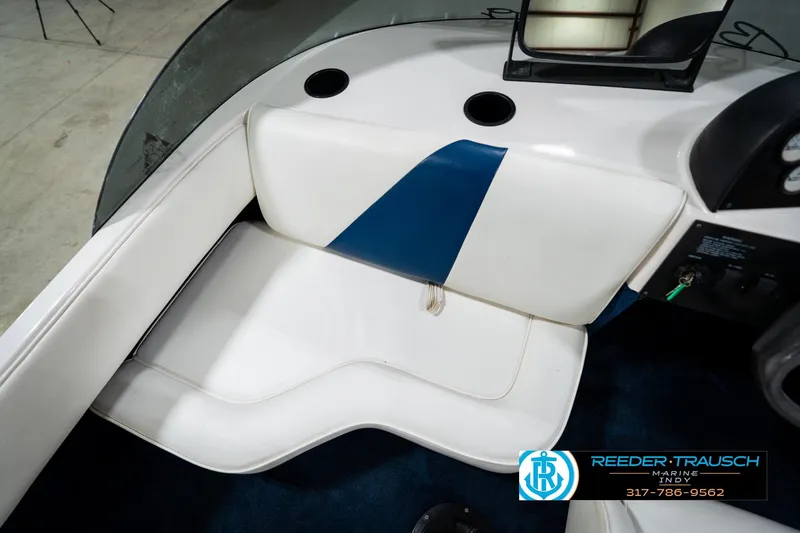 Slide: The Image of Interior of a 1997 Moomba Boomerang boat with white and blue seating. - 31