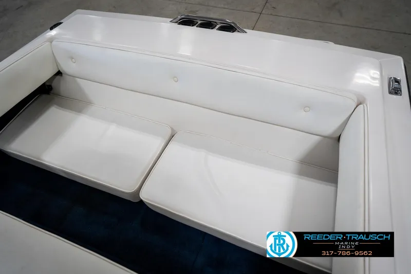 Slide: The Image of 1997 Moomba Boomerang boat interior with white and blue seating, steering controls, and windshield. - 32
