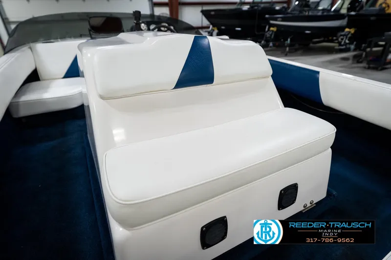 Slide: The Image of 1997 Moomba Boomerang boat interior with white seating and blue carpet. - 33