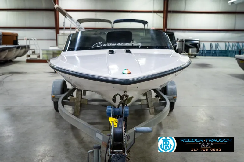 Slide: The Image of 1997 Moomba Boomerang boat on trailer in indoor showroom setting. - 4
