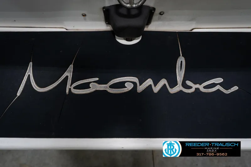 Slide: The Image of 1997 Moomba Boomerang boat in a warehouse, side view with logo visible. - 44