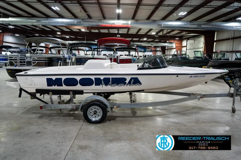 Slide: The Image of 1997 Moomba Boomerang boat on trailer in indoor showroom. - 6