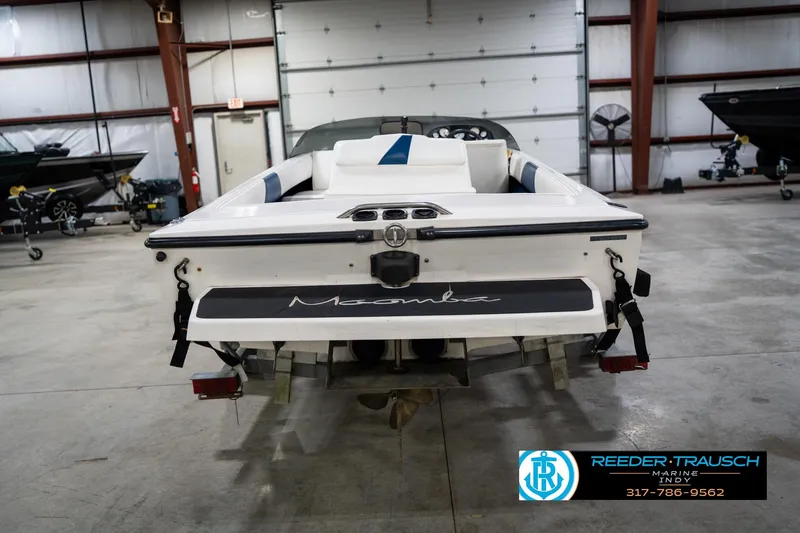 Slide: The Image of 1997 Moomba Boomerang boat on trailer in indoor showroom setting. - 8
