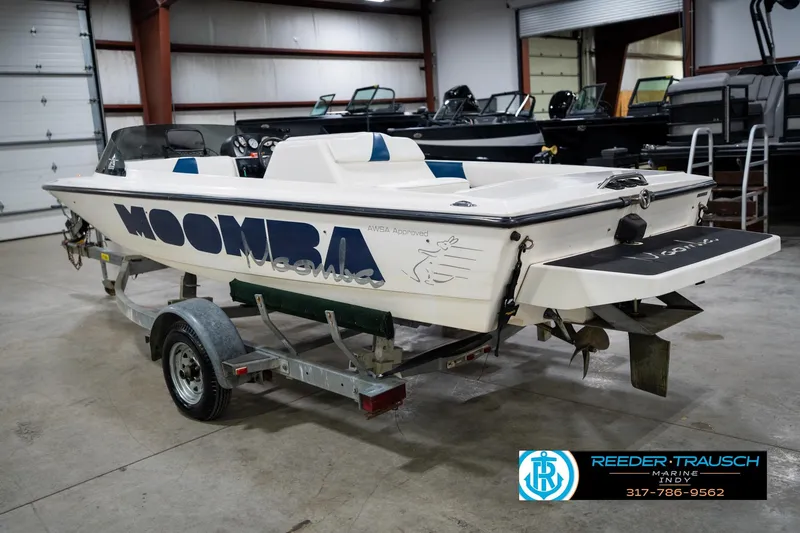 Slide: The Image of 1997 Moomba Boomerang boat in a warehouse, rear view showing interior and propeller. - 9