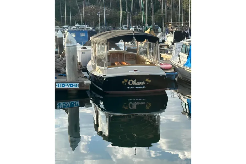 Slide: The Image of 2007 Duffy 22 Electric boat named "Ohana" docked in a marina. - 1