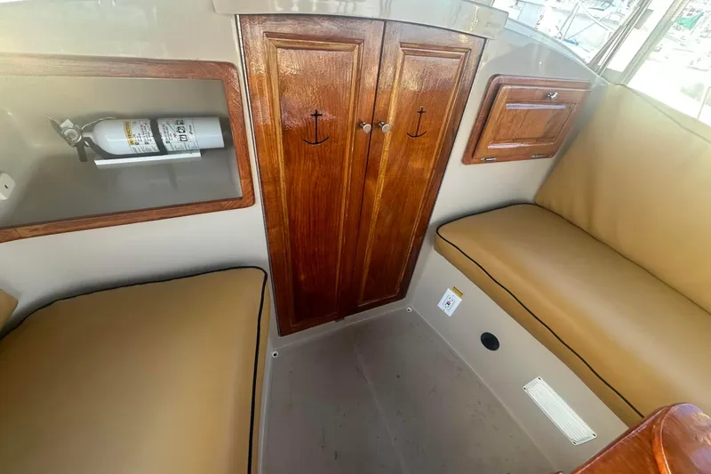 Slide: The Image of Interior of 2007 Duffy 22 Electric boat with wooden cabinets and seating. - 16