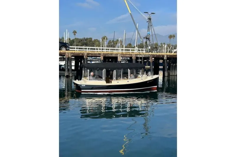 Slide: The Image of 2007 Duffy 22 Cuddy boat docked in a marina with calm water reflections. - 3