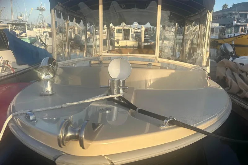 Slide: The Image of 2007 Duffy 22 Electric boat docked at marina, featuring sleek design and modern fixtures. - 4