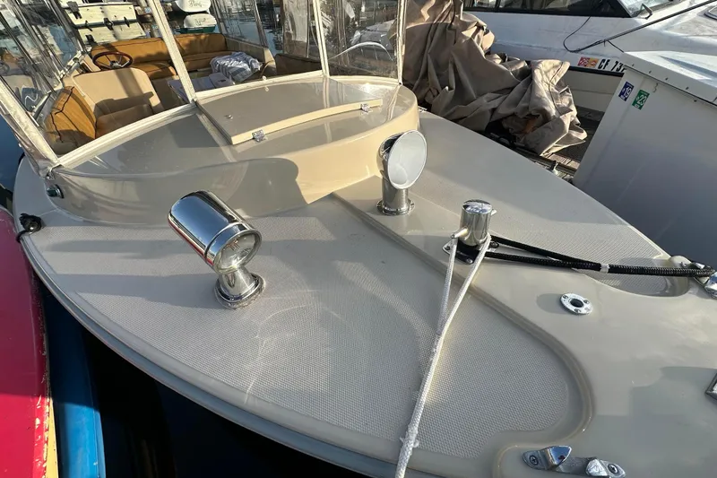Slide: The Image of 2007 Duffy 22 Electric boat deck with chrome fixtures and clear canopy. - 6