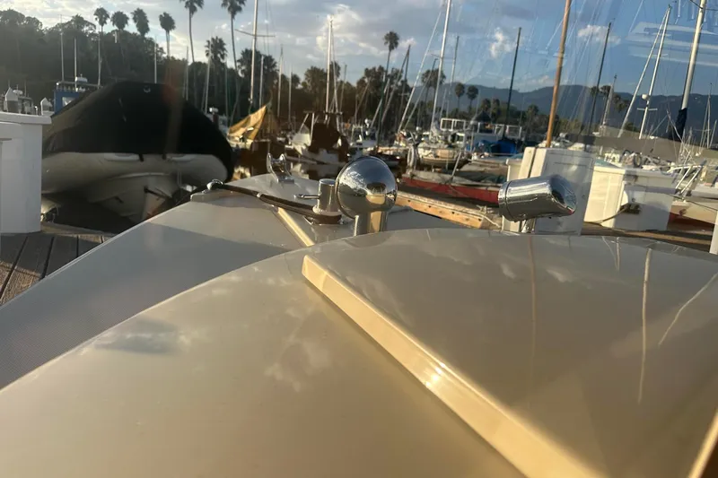 Slide: The Image of 2007 Duffy 22 Electric boat docked at marina with sailboats and palm trees. - 8