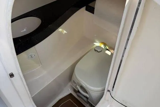 Slide: The Image of 2014 Regal 2500 Bowrider boat interior with compact marine toilet. - 10
