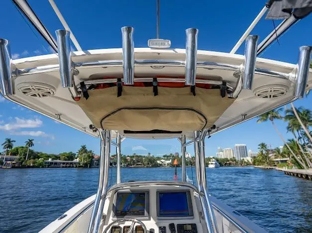 Slide: The Image of Edgewater 318CC boat console with rod holders, cruising on a sunny day, 2010 model. - 14