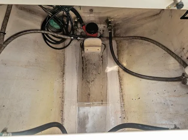 Slide: The Image of Bilge area of a 2010 Edgewater 318CC boat with hoses and pump. - 16