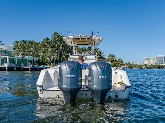 Slide: The Image of 2010 Edgewater 318CC boat with dual 300 horsepower engines on a sunny waterway. - 17