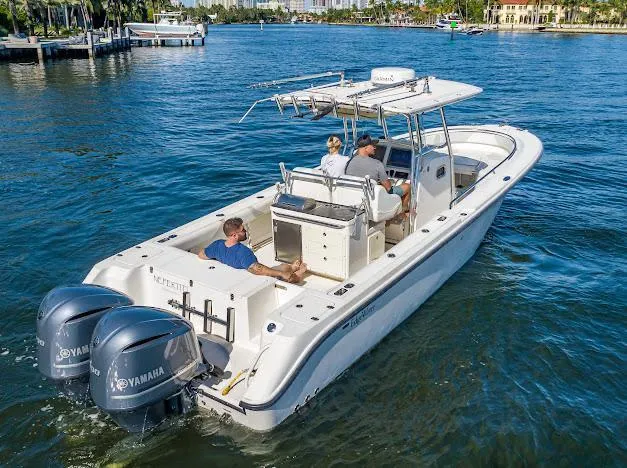 Slide: The Image of 2010 Edgewater 318CC boat cruising on a sunny day with Yamaha engines. - 20