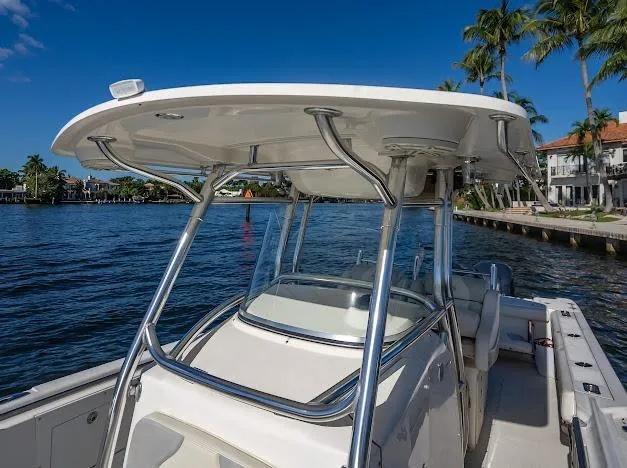 Slide: The Image of Edgewater 318CC 2010 boat on water, featuring sleek design and sturdy T-top. - 22