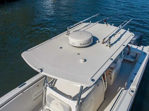 Slide: The Image of 2010 Edgewater 318CC boat with Garmin equipment on calm water. - 24