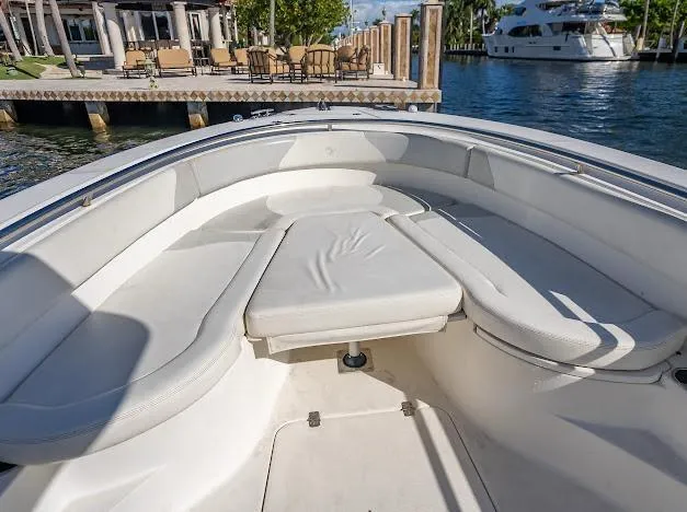 Slide: The Image of Bow seating area of a 2010 Edgewater 318CC boat, docked near a marina. - 25
