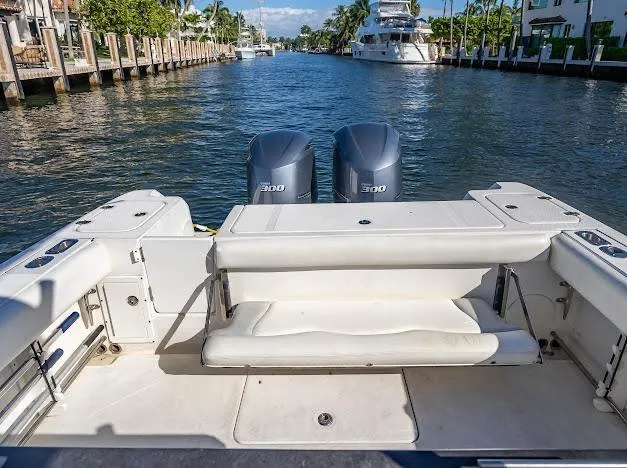 Slide: The Image of 2010 Edgewater 318CC boat with dual 300 horsepower engines on a scenic waterway. - 27