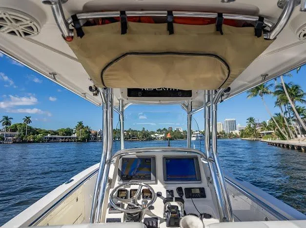 Slide: The Image of Edgewater 318CC 2010 boat cockpit with navigation screens, steering wheel, and ocean view. - 29