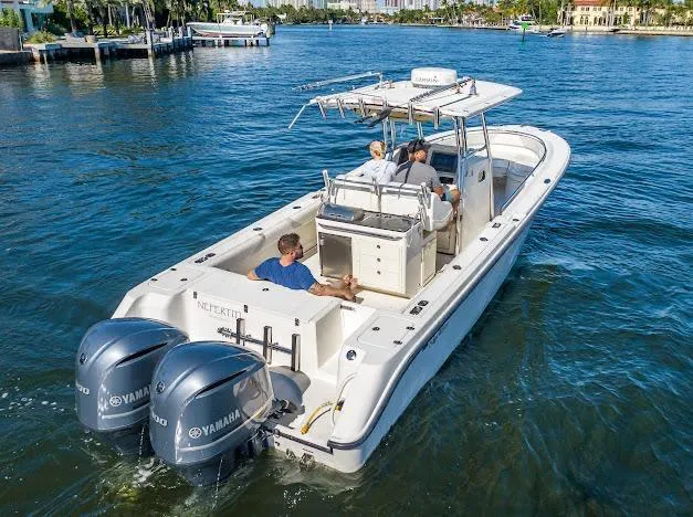 Slide: The Image of 2010 Edgewater 318CC boat with dual Yamaha engines cruising on a sunny waterway. - 33