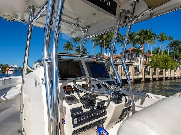 Slide: The Image of 2010 Edgewater 318CC boat cockpit with steering wheel, controls, and waterfront view. - 35