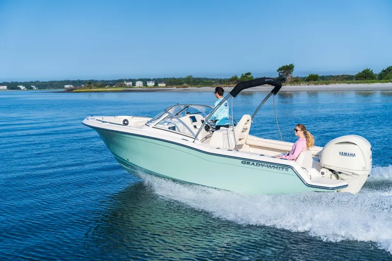 Slide: The Image of 2026 Grady-White Freedom 215 boat cruising on serene blue waters. - 1