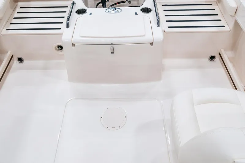 Slide: The Image of 2026 Grady-White Freedom 215 boat interior, featuring seating and storage compartments. - 4